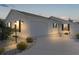 White house with two-car garage and landscaped front yard at night at 446 Flossmoor Ct, The Villages, FL 32162