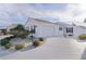White house with two-car garage and landscaped front yard at 446 Flossmoor Ct, The Villages, FL 32162