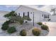 White house exterior with landscaping and driveway at 446 Flossmoor Ct, The Villages, FL 32162