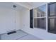 White front door with black shutters and a welcome mat at 446 Flossmoor Ct, The Villages, FL 32162