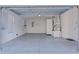 Spacious garage with painted floor and extra storage at 446 Flossmoor Ct, The Villages, FL 32162