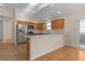 Open concept kitchen with island and stainless steel appliances at 446 Flossmoor Ct, The Villages, FL 32162