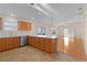 Open concept kitchen with island and stainless steel appliances at 446 Flossmoor Ct, The Villages, FL 32162