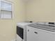 Laundry room with side-by-side washer and dryer at 446 Flossmoor Ct, The Villages, FL 32162