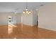 Sunlit living room with hardwood floors and access to patio at 446 Flossmoor Ct, The Villages, FL 32162