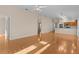 Open living room with hardwood floors and view of kitchen at 446 Flossmoor Ct, The Villages, FL 32162