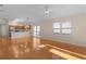 Bright living room with hardwood floors and kitchen views at 446 Flossmoor Ct, The Villages, FL 32162