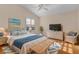 Virtually staged main bedroom with hardwood floors and wicker furniture at 446 Flossmoor Ct, The Villages, FL 32162