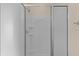 Clean shower with glass enclosure and shelves at 446 Flossmoor Ct, The Villages, FL 32162