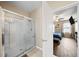 Bathroom with a walk-in shower and bedroom view at 5756 Lakeside Landings Blvd, Winter Haven, FL 33881