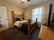 Bedroom features wood-look floors, natural light, and coordinated furniture at 5756 Lakeside Landings Blvd, Winter Haven, FL 33881