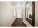 Bright hallway with dark wood floors and a large mirror at 5756 Lakeside Landings Blvd, Winter Haven, FL 33881