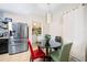 Kitchen nook with table and chairs, stainless steel refrigerator and laundry room access at 5756 Lakeside Landings Blvd, Winter Haven, FL 33881