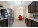 Kitchen features dark cabinets and stainless steel appliances at 5756 Lakeside Landings Blvd, Winter Haven, FL 33881