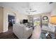 Living room with two sofas, coffee table, and view into adjacent bedroom at 5756 Lakeside Landings Blvd, Winter Haven, FL 33881