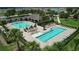 Community pool area with lap lanes, lounge chairs, and a covered pavilion at 5756 Lakeside Landings Blvd, Winter Haven, FL 33881