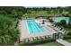 Community pool with plenty of lounge chairs at 5756 Lakeside Landings Blvd, Winter Haven, FL 33881
