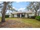 Landscaped backyard with spacious lawn at 610 Fannich Ct, Leesburg, FL 34788