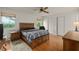 Spacious bedroom with wood platform bed and wood flooring at 610 Fannich Ct, Leesburg, FL 34788