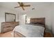 Bedroom with dresser, mirror and ceiling fan at 610 Fannich Ct, Leesburg, FL 34788