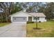 Single-story house with attached garage and well-maintained lawn at 610 Fannich Ct, Leesburg, FL 34788