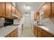 Efficient kitchen with light wood cabinets and modern appliances at 610 Fannich Ct, Leesburg, FL 34788
