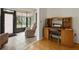 Home office with built-in desk, chair, and sunroom access at 610 Fannich Ct, Leesburg, FL 34788