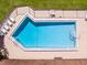 Community swimming pool with lounge chairs at 610 Fannich Ct, Leesburg, FL 34788