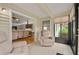 Relaxing sunroom with two comfy armchairs and backyard views at 610 Fannich Ct, Leesburg, FL 34788