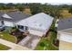 Aerial view of a single-Gathering home with metal roof and landscaped yard at 6342 Sanders Grove Cir, Okahumpka, FL 34762