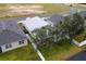 Aerial view of house showcasing backyard, fence, and neighboring houses at 6342 Sanders Grove Cir, Okahumpka, FL 34762