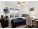 Bedroom with desk workspace and large window at 6342 Sanders Grove Cir, Okahumpka, FL 34762