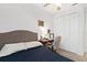 Bright bedroom with a comfortable bed, workspace, and ample closet space at 6342 Sanders Grove Cir, Okahumpka, FL 34762
