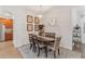 Bright dining room with oval table and six chairs, adjacent to kitchen at 6342 Sanders Grove Cir, Okahumpka, FL 34762