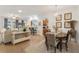 Open dining room with large table and access to living area at 6342 Sanders Grove Cir, Okahumpka, FL 34762