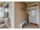 Inviting front entry with a bench and welcome mat at 6342 Sanders Grove Cir, Okahumpka, FL 34762