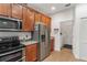 Kitchen features stainless steel appliances and ample wood cabinetry at 6342 Sanders Grove Cir, Okahumpka, FL 34762
