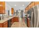 Galley kitchen with wood cabinets and stainless steel appliances at 6342 Sanders Grove Cir, Okahumpka, FL 34762