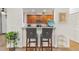 Kitchen breakfast bar with two gray barstools at 6342 Sanders Grove Cir, Okahumpka, FL 34762