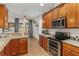 Bright kitchen with stainless steel appliances and wood cabinets at 6342 Sanders Grove Cir, Okahumpka, FL 34762