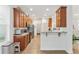 Updated kitchen with wood cabinets, stainless steel appliances and breakfast bar at 6342 Sanders Grove Cir, Okahumpka, FL 34762