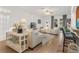 Spacious living room with light beige sofas and tiled floors at 6342 Sanders Grove Cir, Okahumpka, FL 34762