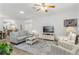 Relaxing living room featuring comfortable seating and a large TV at 6342 Sanders Grove Cir, Okahumpka, FL 34762