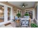 Relaxing screened porch with seating and ceiling fan at 6342 Sanders Grove Cir, Okahumpka, FL 34762