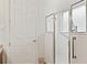Walk-in shower with grab bars and glass enclosure at 6342 Sanders Grove Cir, Okahumpka, FL 34762