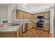 Kitchen with stainless steel appliances and light wood cabinets at 660 Whitetail Loop, Apopka, FL 32703