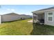 Spacious backyard with covered patio and grassy lawn at 6764 Mary Loop, The Villages, FL 34762