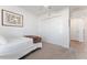Bright bedroom with twin bed, carpet, and double door closet at 6764 Mary Loop, The Villages, FL 34762