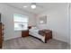 Cozy bedroom with a twin bed, nightstand and window at 6764 Mary Loop, The Villages, FL 34762