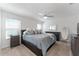 Spacious bedroom with a king-size bed, nightstands, and large windows at 6764 Mary Loop, The Villages, FL 34762